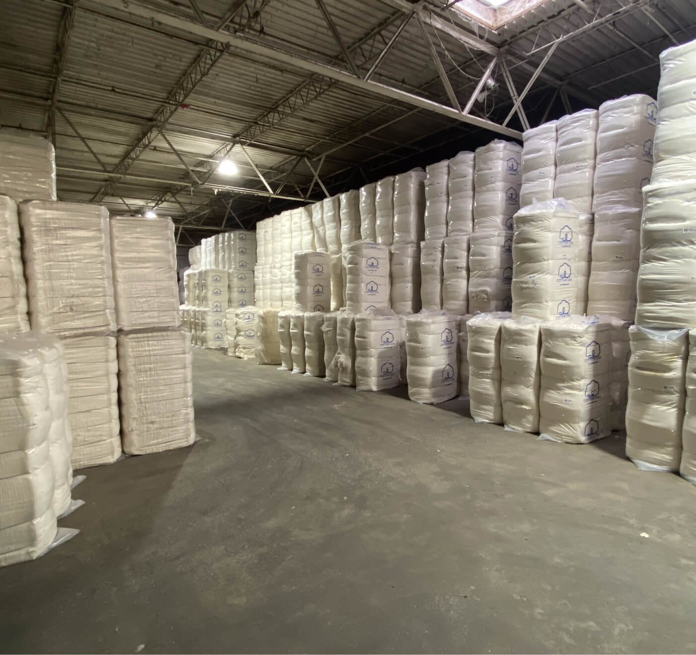 Inside the Salvage Trading warehouse — stacked bales of recycled material