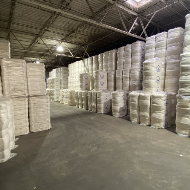 Stacked cotton bales in the Salvage Trading warehouse